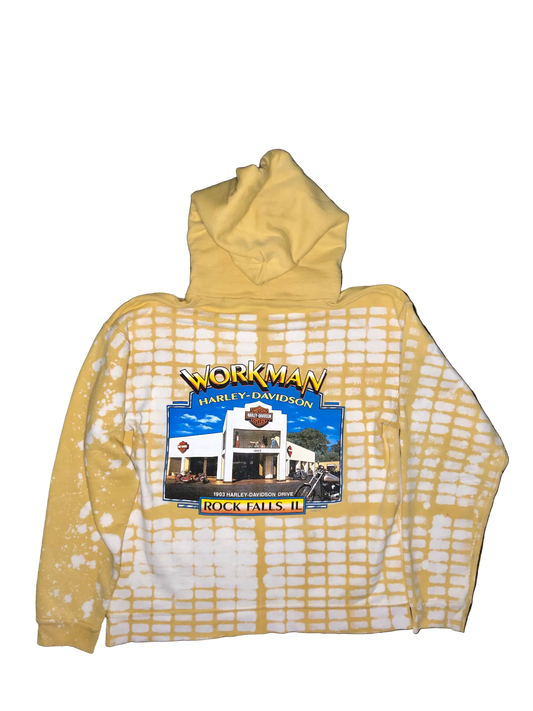 Yellow hoodie with a graphic of a building and 'Workman Harley Davidson' text on a dark background